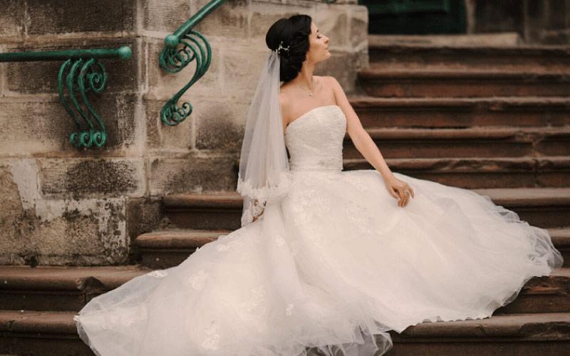 a bride posing in front of Larnach Castle, goth weddings, October 2024, NZ